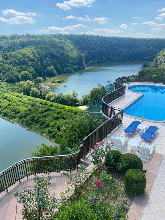 a swimming pool with a view of a river at ХОТЕЛ ВИЛА Мая in Pleven