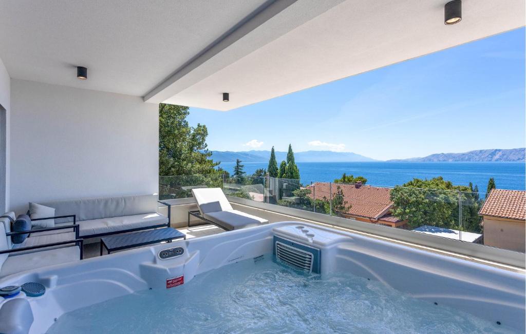 a hot tub in a room with a view of the ocean at Gorgeous Apartment In Novi Vinodolski in Novi Vinodolski