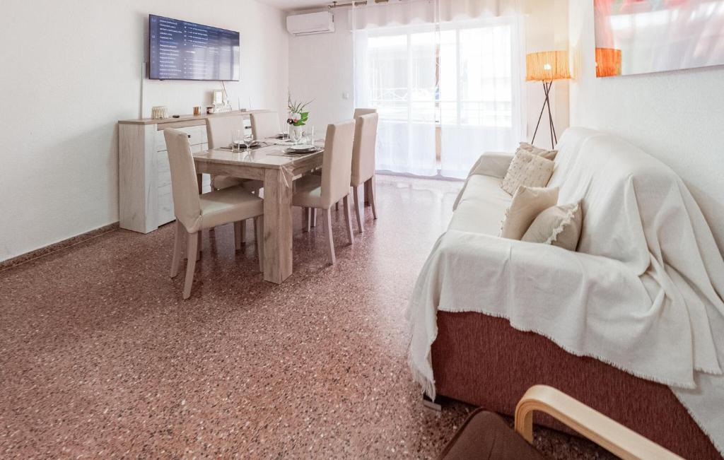 a living room with a table and a couch at Awesome Apartment In Torrevieja in Torrevieja