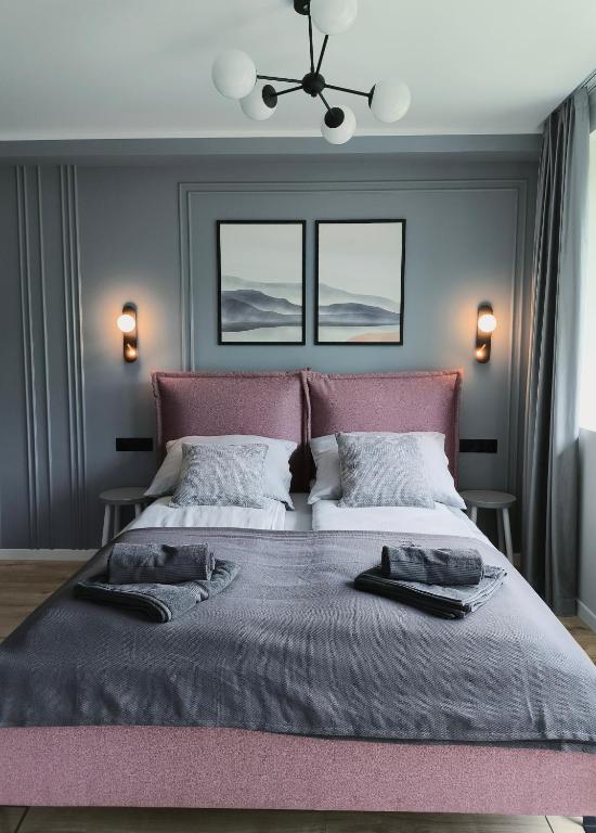 a bedroom with a large bed with two windows at Heima in Zawoja