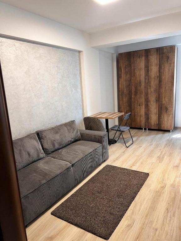 a living room with a couch and a table at Rion Apartment in Saturn