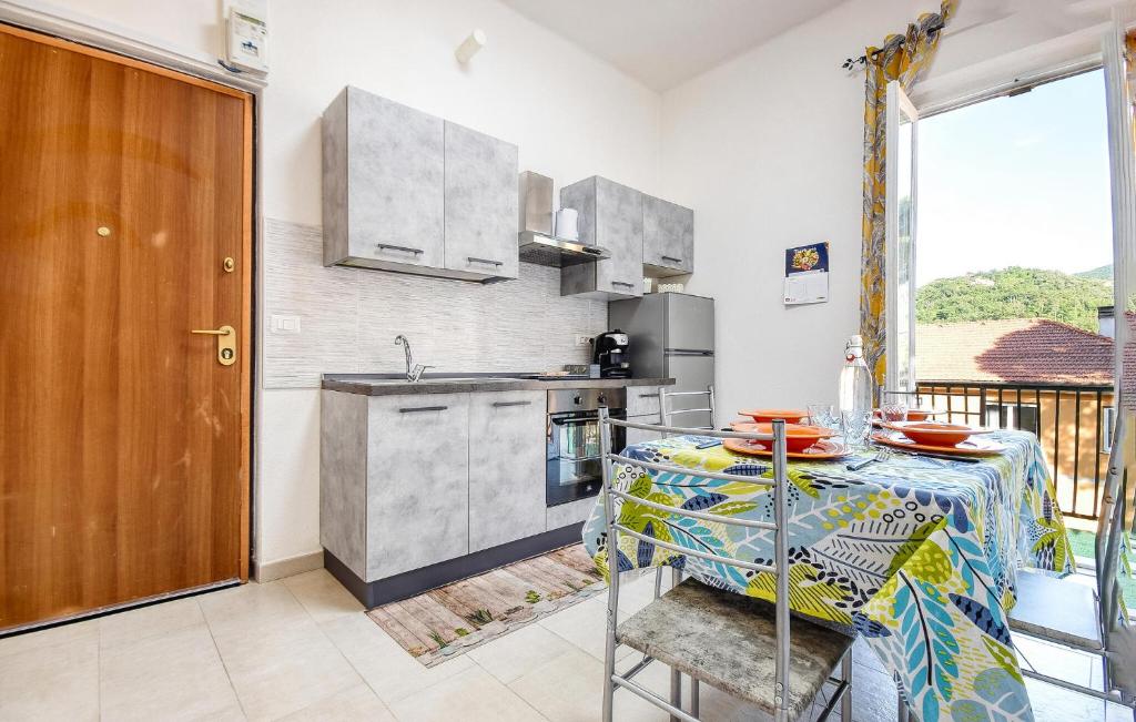 a kitchen with a table and a kitchen with a table and chairs at Awesome Apartment In Casarza Ligure in Casarza Ligure