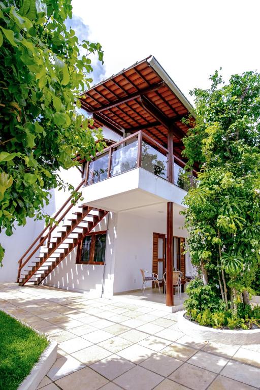 a house with a staircase to the second floor at Lovely Pipa in Pipa