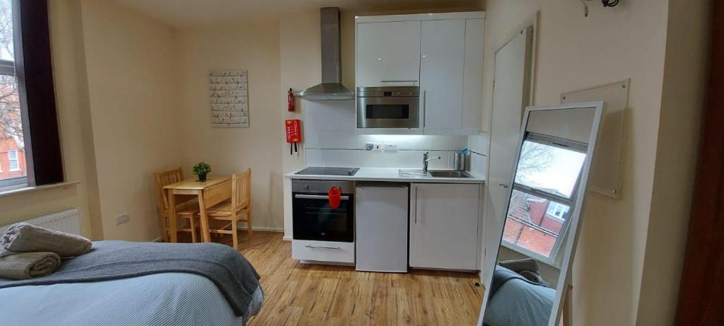 a small kitchen with a sink and a stove at 37chats studio in London