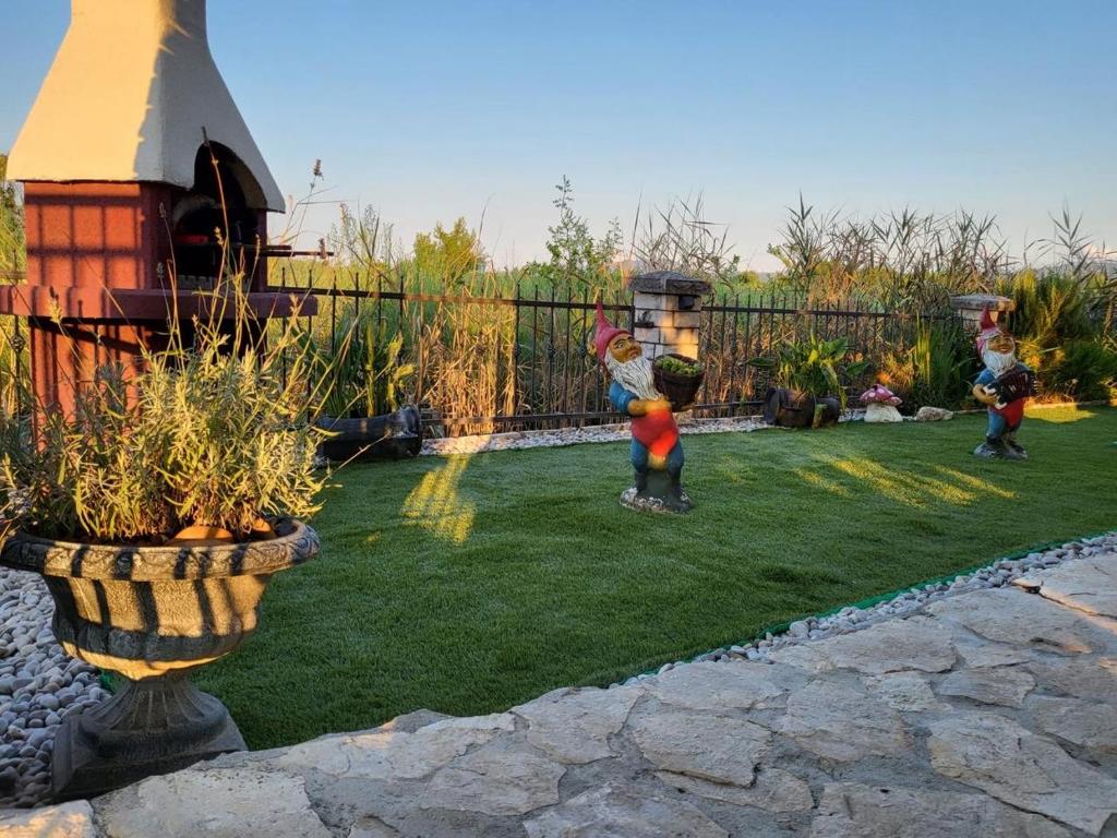 two children playing in the grass in a backyard at Kuća za odmor Nera in Komin