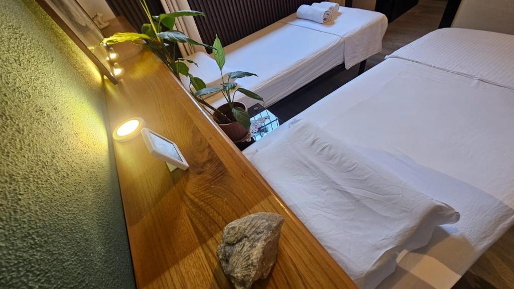 a room with two beds and a light on the wall at UnionBNB Apartments in Tirana