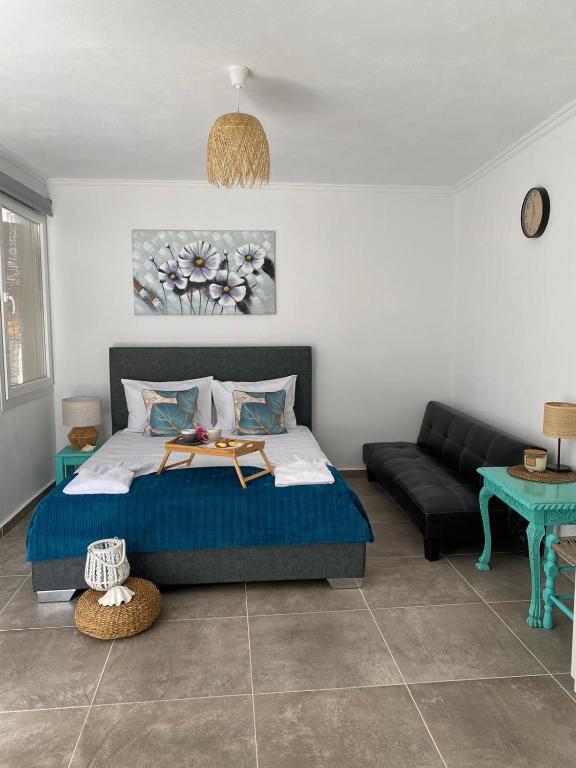 a bedroom with a bed and a couch at Yaya house in Skala Sotiros