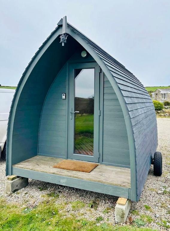 a dome house with a door in the middle at Yule Tree Campsite in Helston
