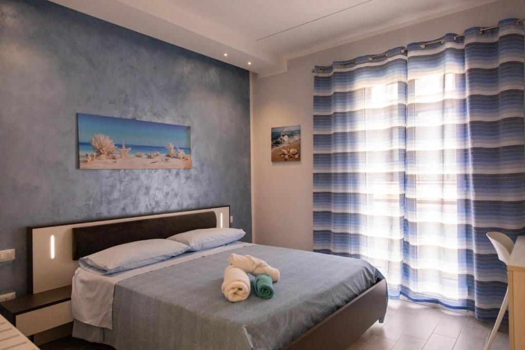 Postel nebo postele na pokoji v ubytování Pietre Azzurre Rooms