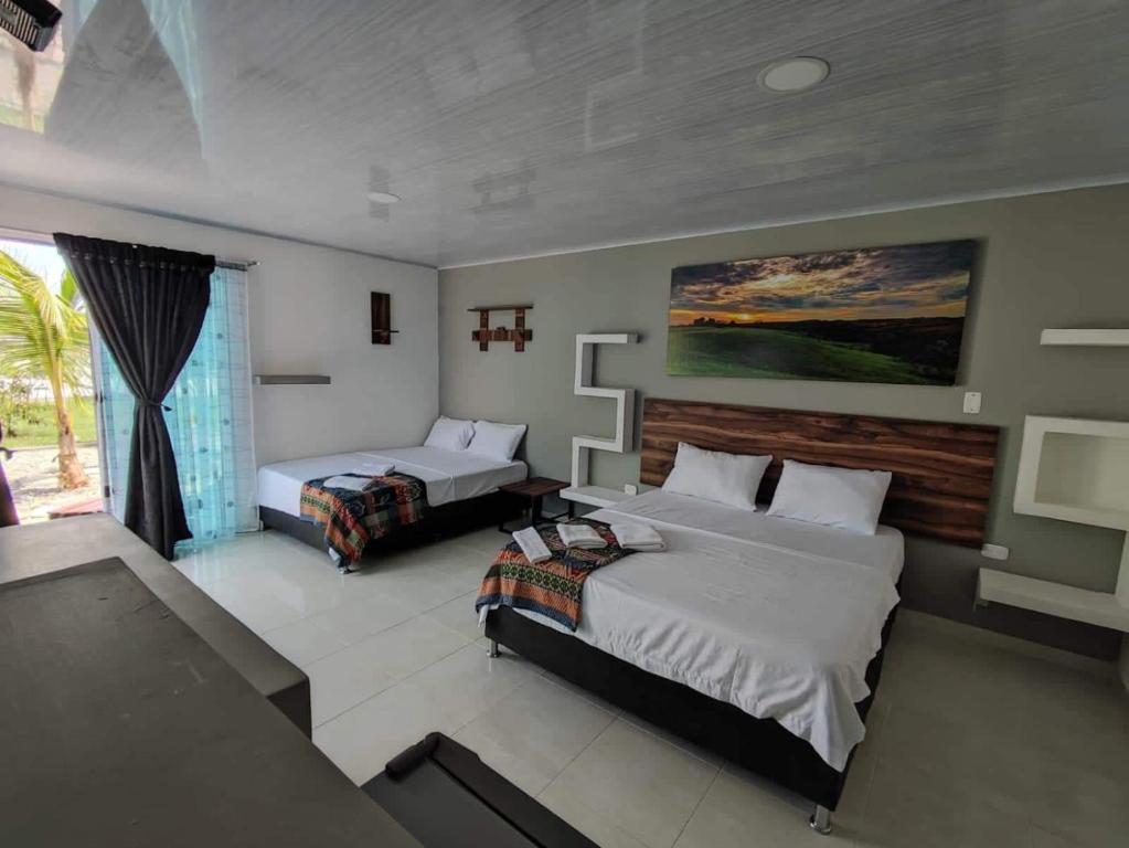 Voodi või voodid majutusasutuse Hotel - Rancho JJ toas