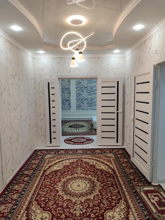 a room with a large rug on the floor at Bayel Guest house in Kochkorka