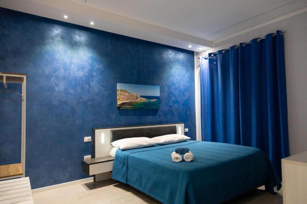Postel nebo postele na pokoji v ubytování Pietre Azzurre Rooms