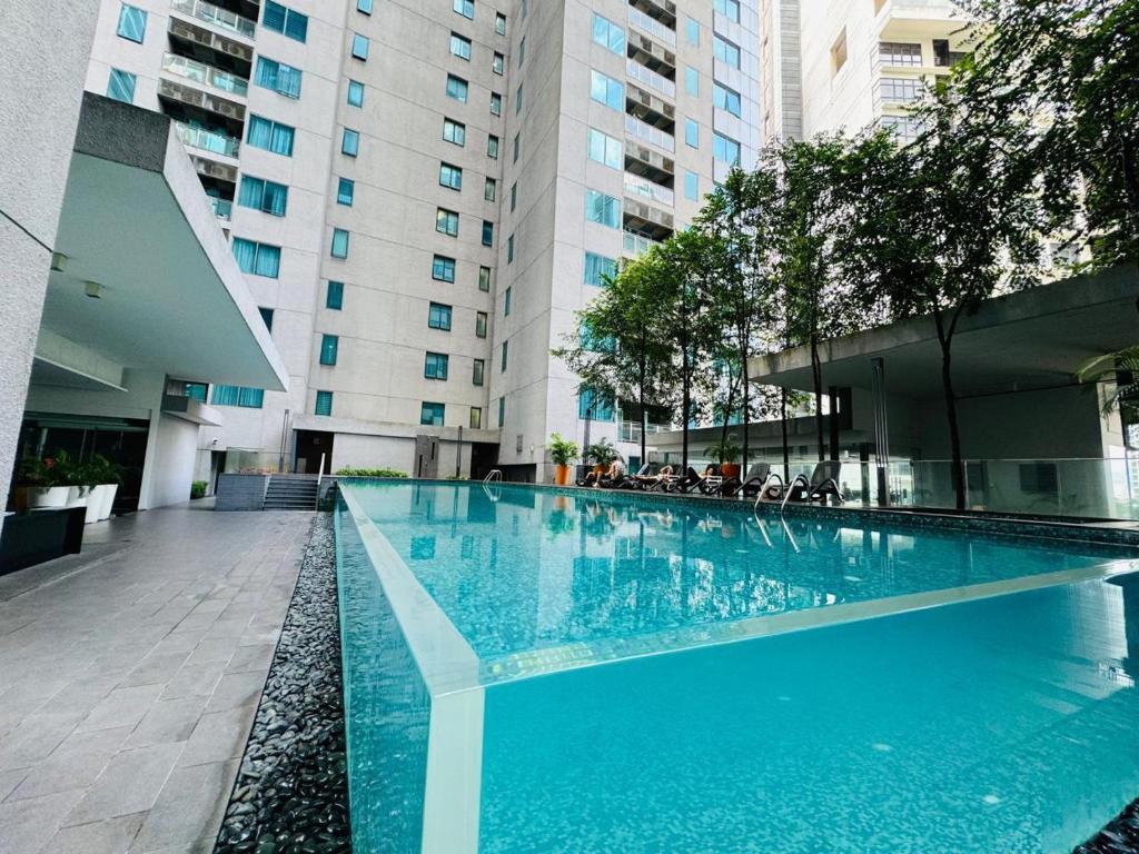 a large swimming pool in the middle of a building at Summer Suites Studio With Balcony Nearby KL City Centre in Kuala Lumpur
