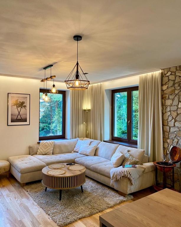 a living room with a couch and a table at Dream House - Vysoké Tatry in Vysoké Tatry