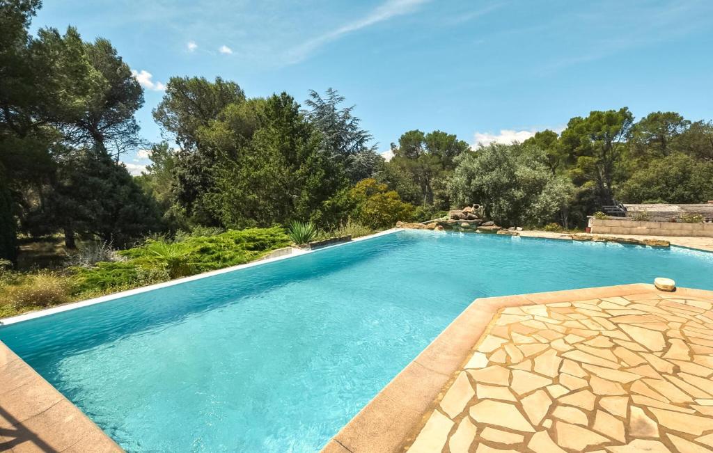 a swimming pool in a yard with trees at Stunning Home In Uchaux in Uchaux