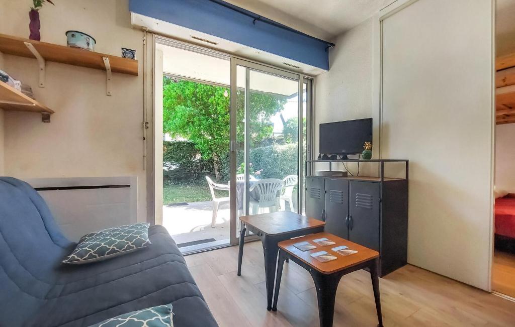 a living room with a couch and a table at 1 Bedroom Amazing Apartment In Carnac in Carnac