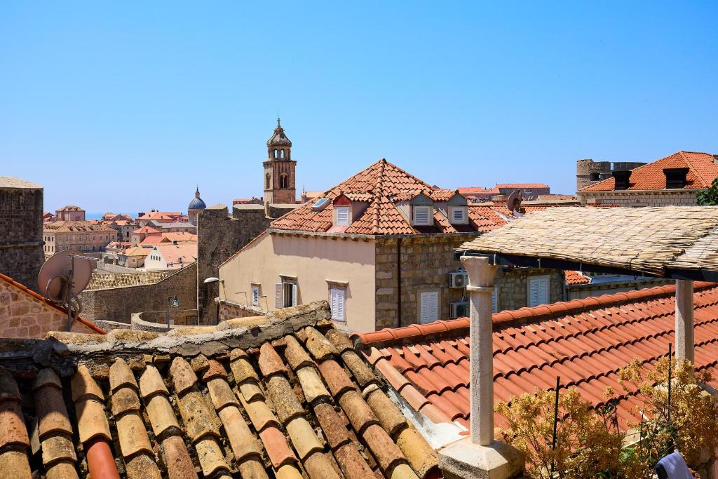a view of roofs of a city with a clock tower at Karma Suites by Dominium in Dubrovnik