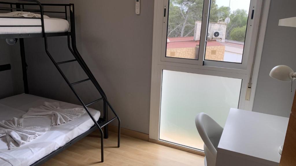 A bed or beds in a room at Apartamento Ginette SunBeach