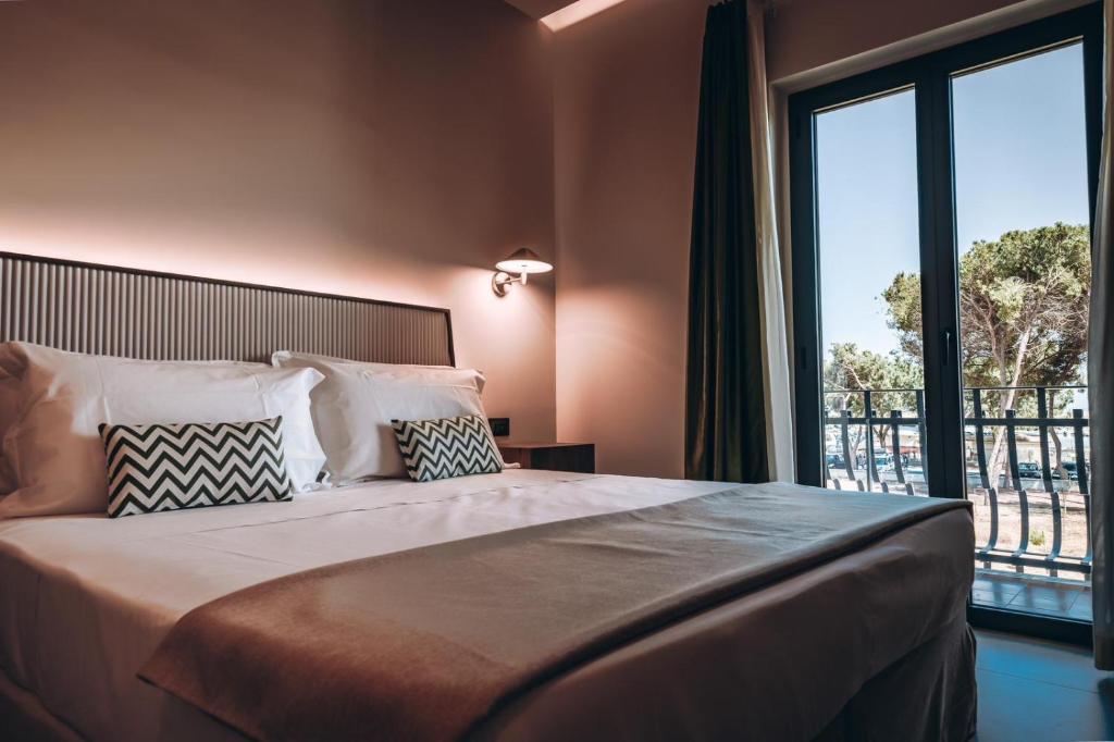 Postel nebo postele na pokoji v ubytování ananea Tropea Yachting Resort