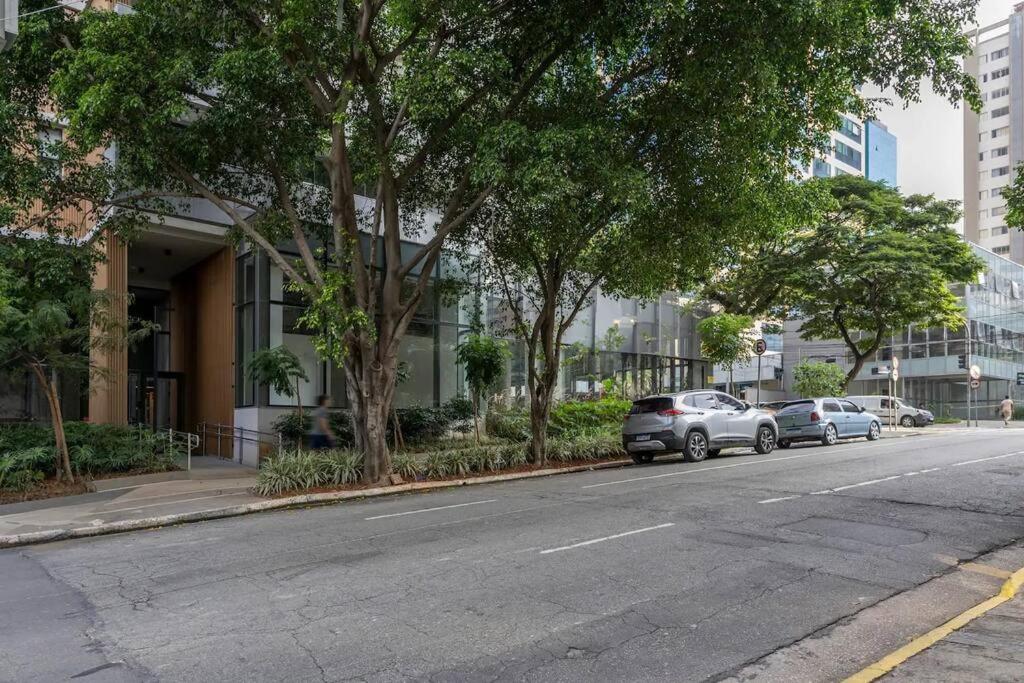 dois carros estacionados ao lado de uma rua com árvores em Studio Especial Moema pra você! em São Paulo