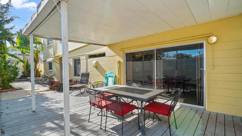 a patio with a table and chairs on a deck at Waves 1 in St Pete Beach