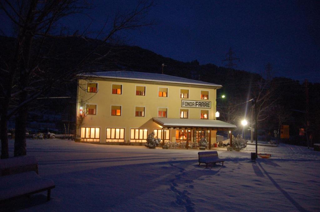 
a large building with a snow covered porch at Fonda Farré in Baro
