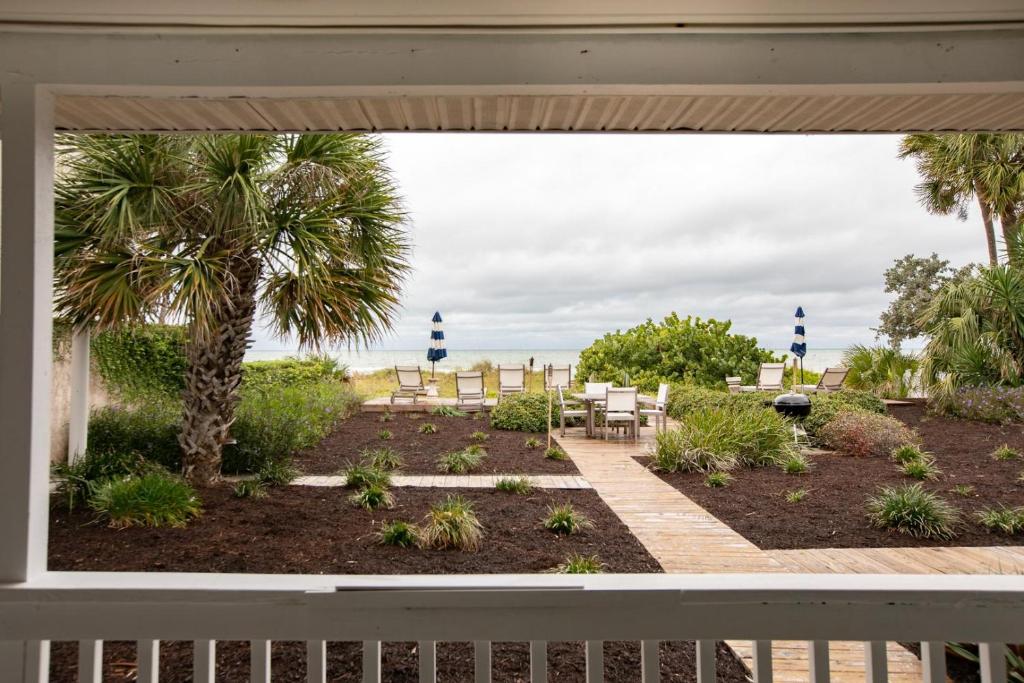 a porch with a view of the beach through a window at Beach Trail Bungalow Triplex in Clearwater Beach