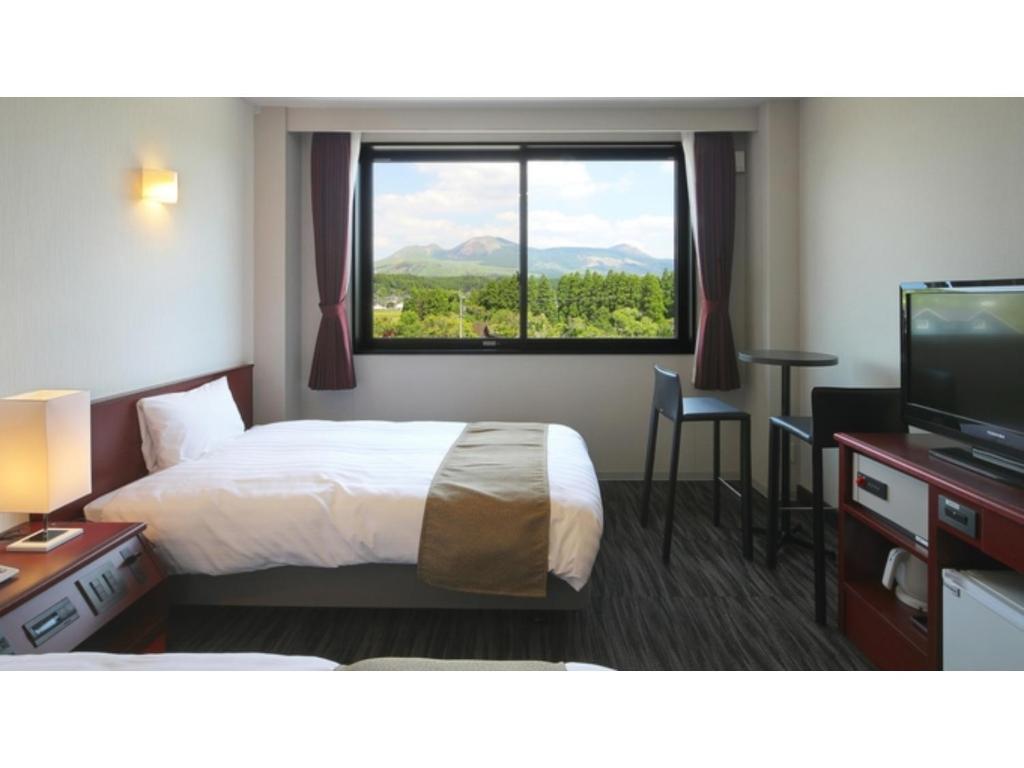 a hotel room with a bed and a large window at Aso Hakuun Sanso - Vacation STAY 77849v in Aso