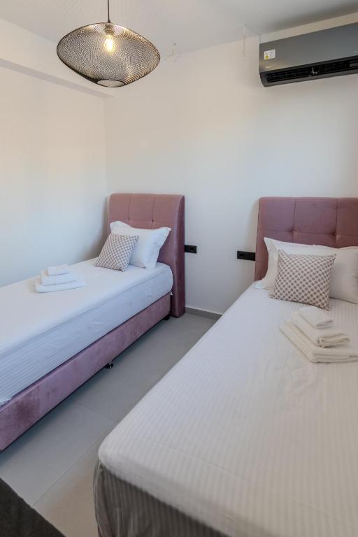 Postel nebo postele na pokoji v ubytování Ventum Villas