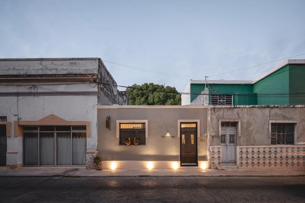 a white house with lights on a street at Itinerante/Casa del Mago. Mérida in Mérida