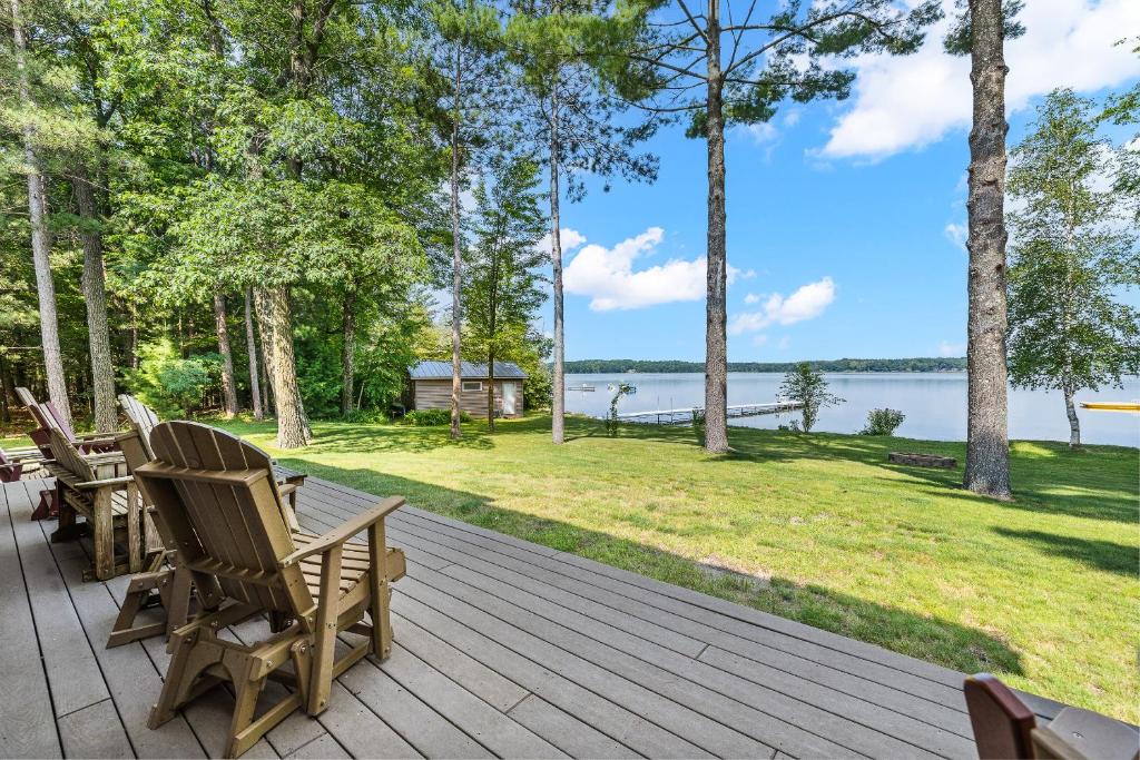 a deck with chairs and a view of the water at Family-Friendly 5BR House by the Lake in Wautoma