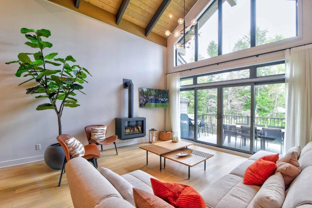 a living room with a couch and a fireplace at Verbier C - Mont-Tremblant Pool Spa and Gym in Mont-Tremblant