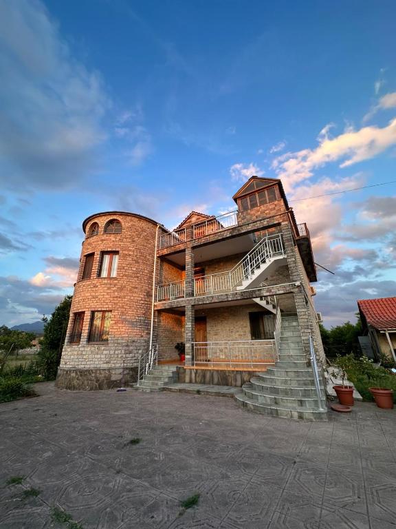 a large brick building with stairs in front of it at The Cuni Castle in Shkodër