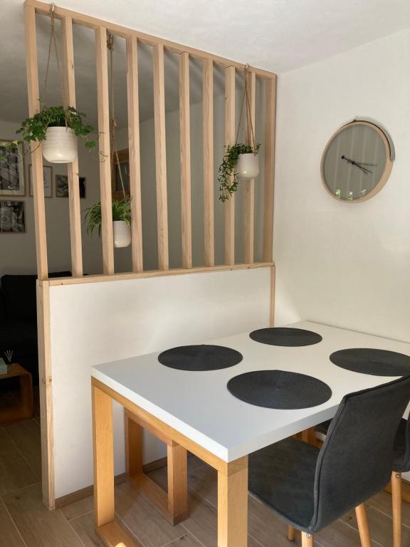 a table and chairs in a room with a staircase at Casa sul ruscello - piano terra Casa Gauguin in Arcegno