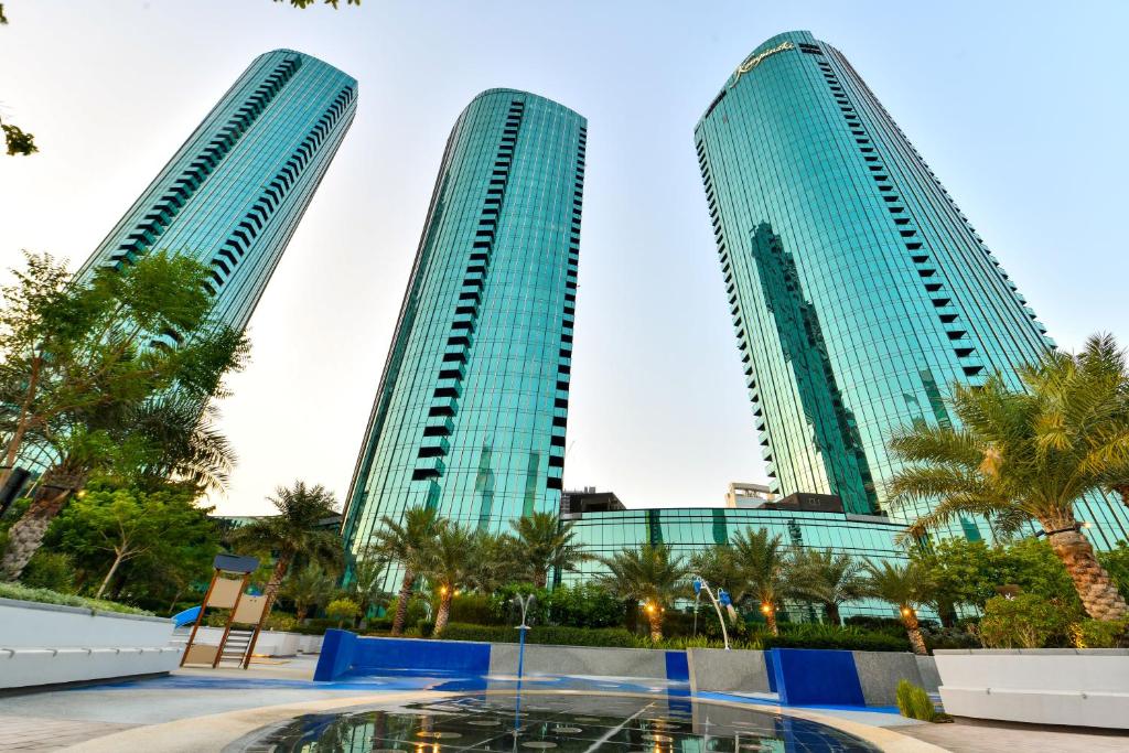 two tall buildings in a city with palm trees at Luxury Seaview Penthouse Harbour Heights in Manama