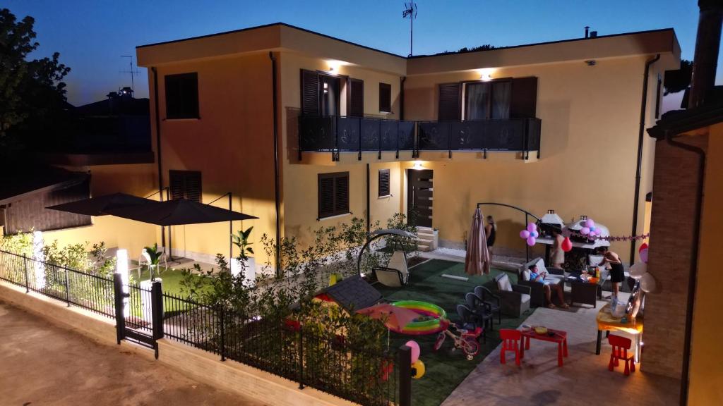 a house with a backyard with a play yard at MirabiLuxury in Borgo Fosso Ghiaia