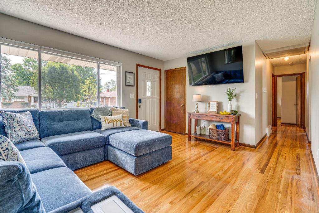 a living room with a blue couch and a tv at Columbus Vacation Rental, 7 Mi to Downtown! in Columbus