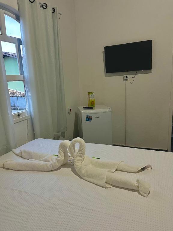 Postel nebo postele na pokoji v ubytování Pousada Recanto da Luísa