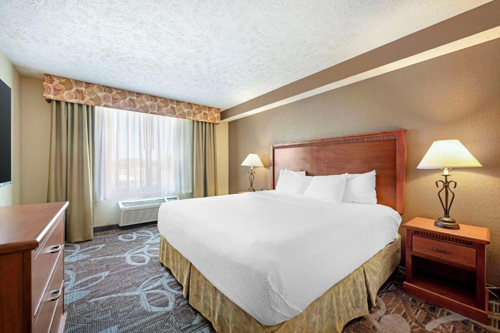 a hotel room with a large bed and a window at Best Western Plus Mid Nebraska Inn & Suites in Kearney