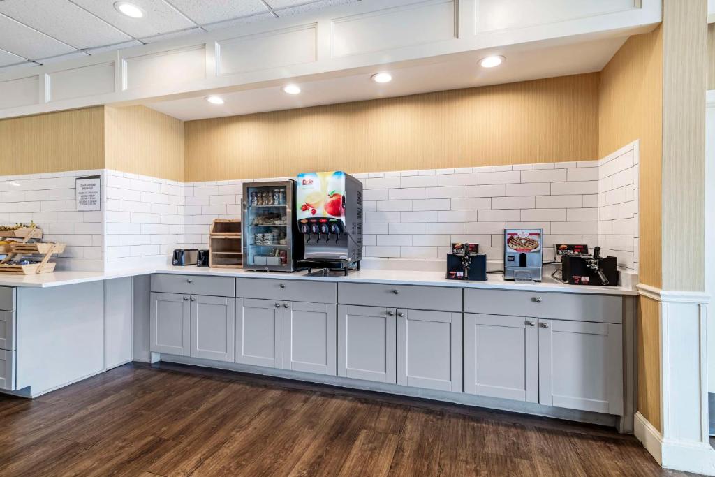 a kitchen with white cabinets and a counter top at Best Western Springfield Hotel in Springfield