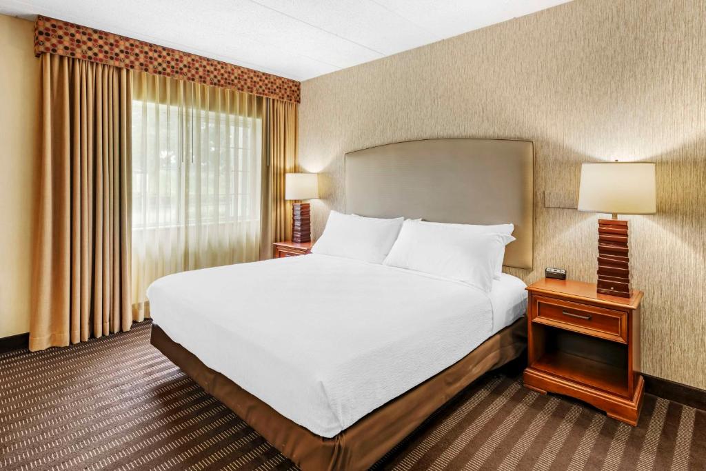 a hotel room with a large bed and a window at Best Western Springfield Hotel in Springfield