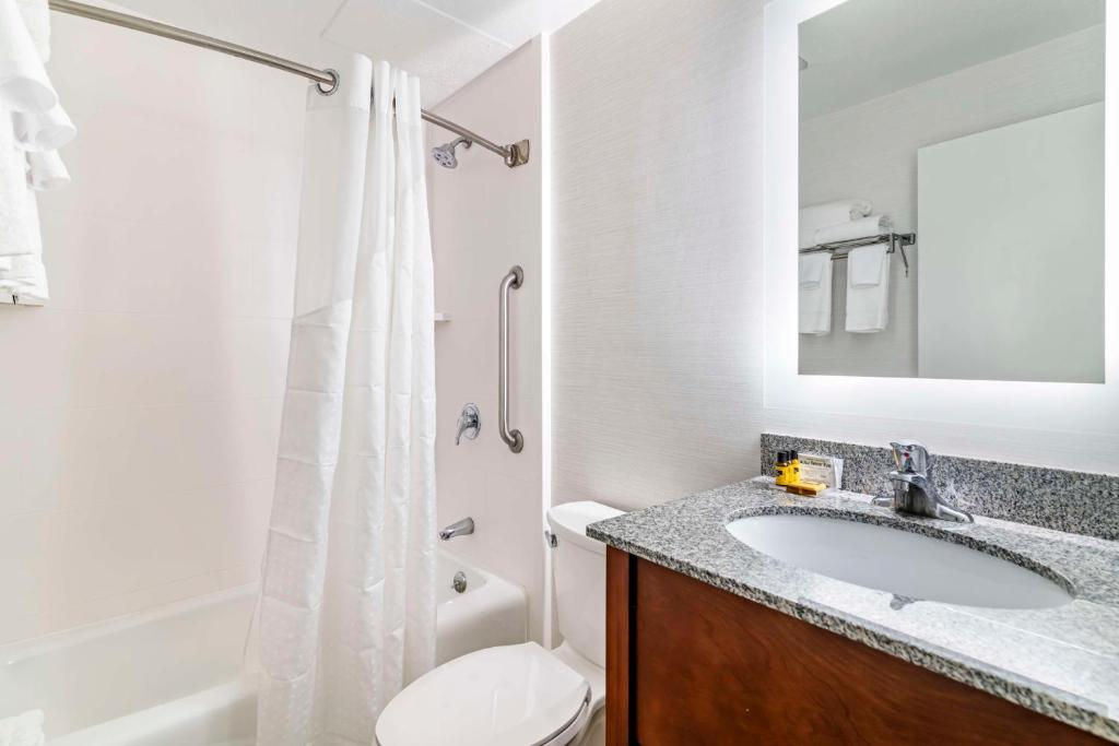a bathroom with a sink and a toilet and a shower at Best Western Springfield Hotel in Springfield