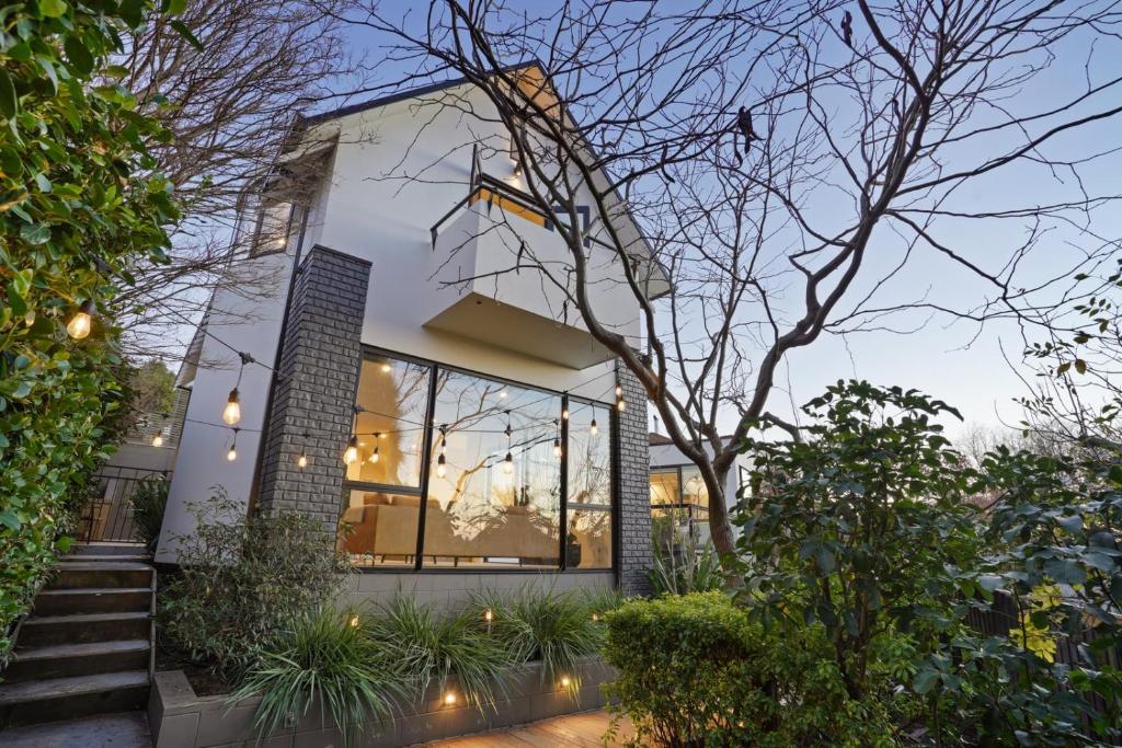a house with glass windows and plants in front of it at Overdale Oasis in Christchurch