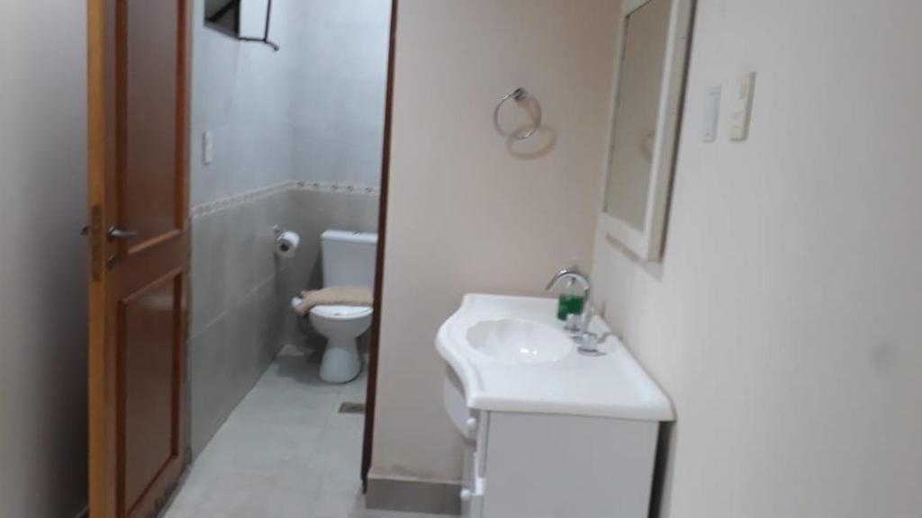 a bathroom with a sink and a toilet at Temporario Aguilares in Aguilares