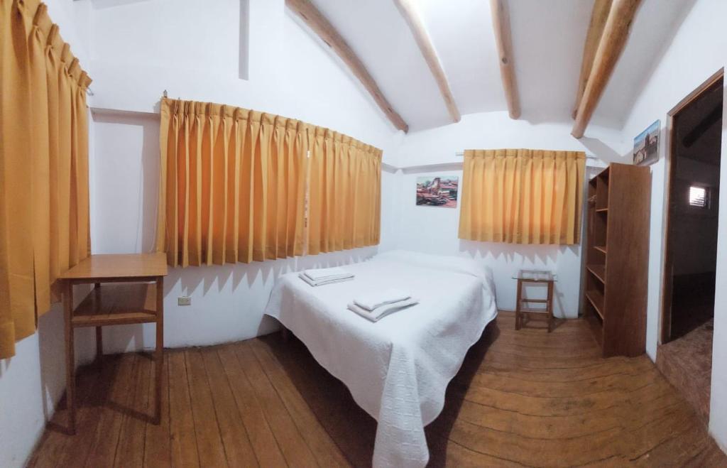 Postel nebo postele na pokoji v ubytování Hostal Miramonti