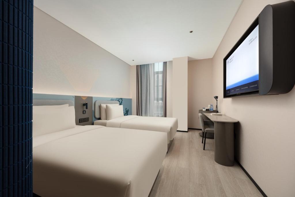 Letto o letti in una camera di Atour Light Hotel Wuxi Taihu Lake Expo Center Financial Street