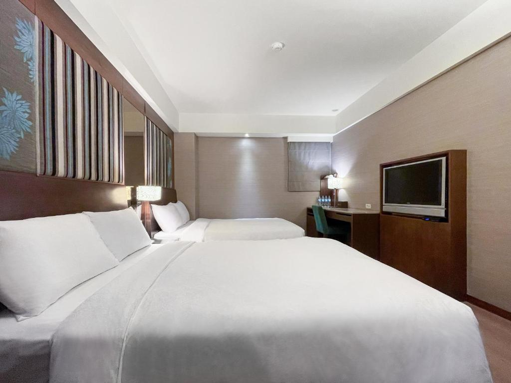 Postel nebo postele na pokoji v ubytování Guide Hotel Taipei NTU