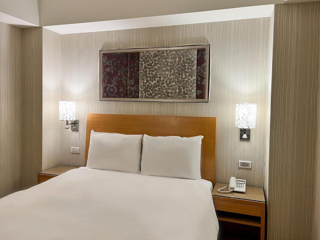 Postel nebo postele na pokoji v ubytování Guide Hotel Taipei NTU