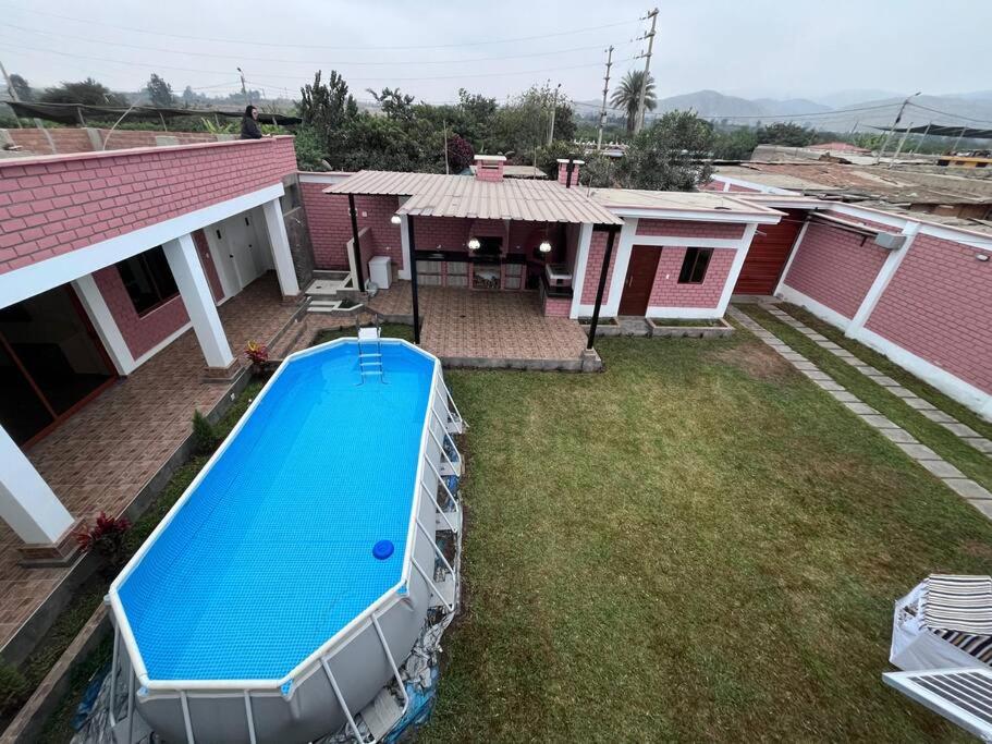 a swimming pool in the yard of a house at Villa Guerrero - Casa de Campo in Larán