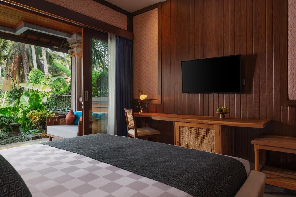 Postel nebo postele na pokoji v ubytování The Artini Dijiwa Ubud
